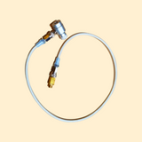 A white adapter kit for a rapid infusion machine with metallic connectors and a flexible tube.