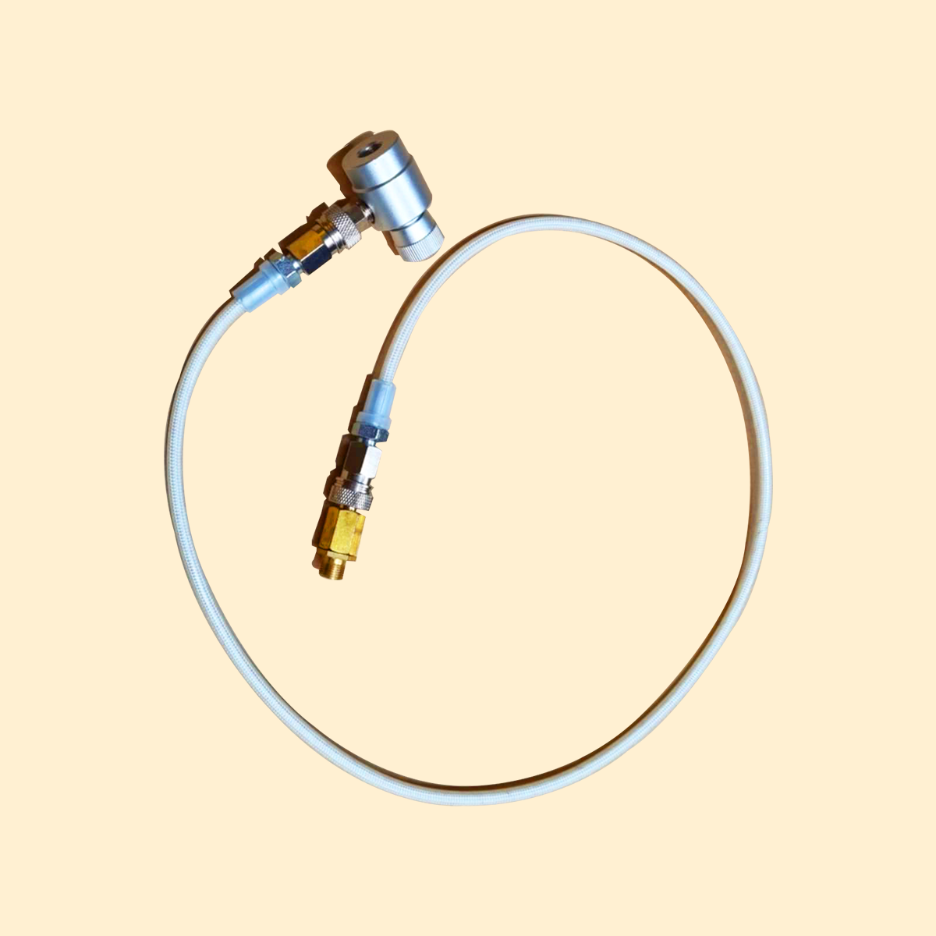 A white adapter kit for a rapid infusion machine with metallic connectors and a flexible tube.